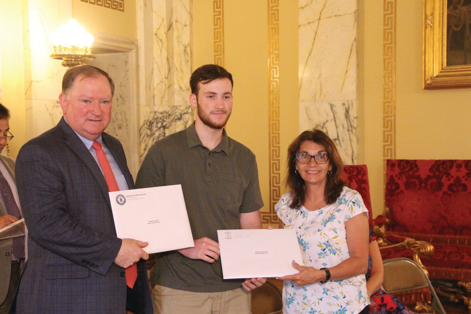 STATE CERTIFIED: Rhode Island state Senate Majority Leader Michael J. McCaffrey (D-Dist. 29, Warwick) and state Rep. Deborah A. Fellela (D-District 43, Johnston) presented citations to outstanding Academic Decathlon competitors from Johnston at a recent State House ceremony. Benjamin Annicelli accepted a citation.
